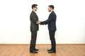 The two businessmen handshake on the white wall background Photo