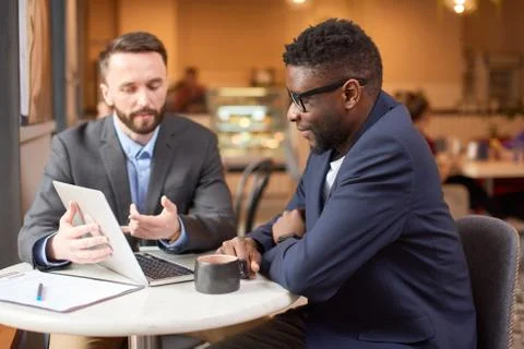 Two businessmen having a look at the computer screen. Stock Photos