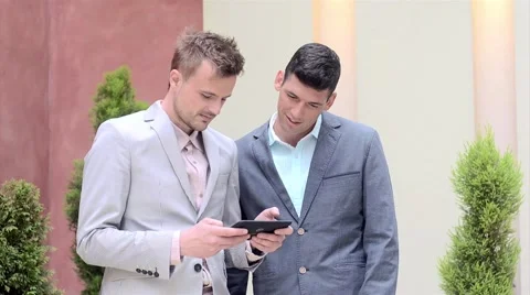 Two businessmen looking at tablet and discussing Stock Footage 61237310
