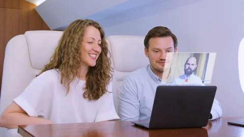 Two businessmen make video call on private plane Stock Footage 114308560