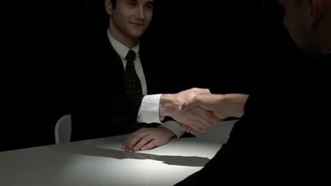 Two businessmen making handshake in dark shadow Stock Footage 90550956
