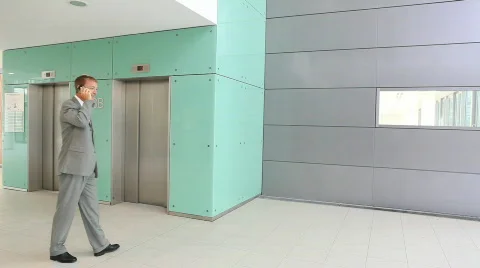 Two businessmen meeting at elevator TWO TAKES Stock Footage 492291