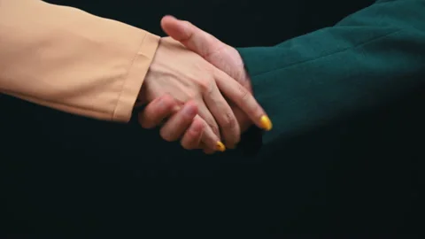 Two Businessmen Shake Hands on a Black Background, Good Deal Stock Footage 200733967