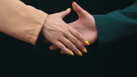 Two Businessmen Shake Hands on a Black Background, Good Deal Stock Footage 200834705