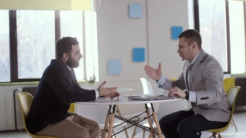 Two businessmen shaking hands with each other before starting business Stock Footage 123411328