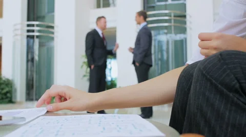 Two businessmen stand in a corridor and roughly discuss plans for work Stock Footage 57457436