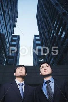 Two businessmen standing side by side outdoors, Beijing Stock Photos