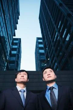 Two businessmen standing side by side outdoors, Beijing Stock Photos