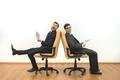 The two businessmen with a tablet and papers sit on the white wall background Photo