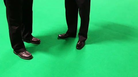 Two businessmen talking on green background Stock Footage 38388683