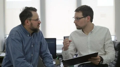 Two businessmen talking in office Stock Footage 97351810