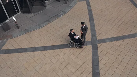 Two Businessmen talking outdoors close to Corporate Building. Colleague is on Stock Footage 110259352