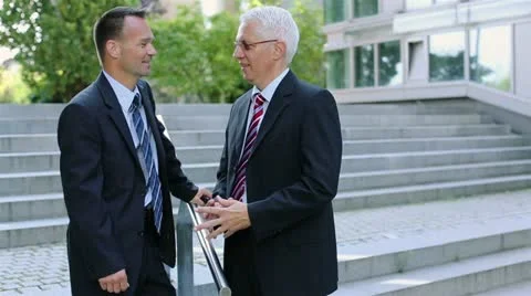 Two businessmen talking outside Video stock 12228353