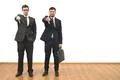 The two businessmen thumb down on the white wall background Photo