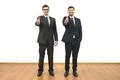 The two businessmen thumb up on the white wall background Photo