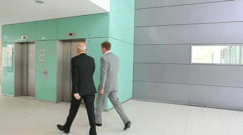 Two businessmen using elevator Stock Footage 492281