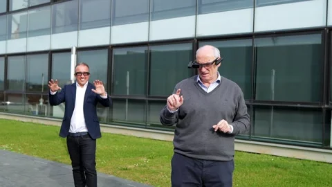 Two Businessmen Using Virtual Reality Glasses Outside Modern Office Building Stock-Footage 275861011