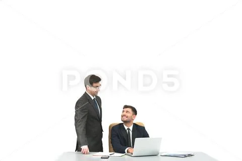 The two businessmen work at the desktop on the white background Stock Photos