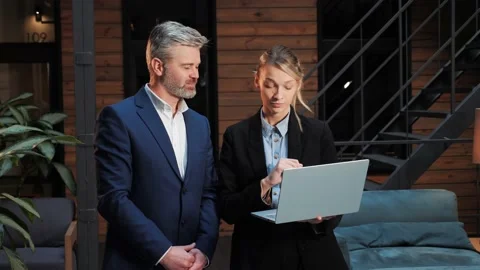 Two businessmen work on financial statistics analyzing charts in report. Stock Footage 232474918