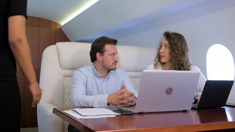 Two businessmen work on private plane Stock Footage 113143518