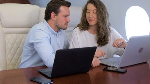 Two businessmen work on private plane Stock Footage 113998992