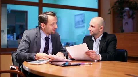 Two businessmen working with documents in the office, steadicam shot HD Video stock 10760947