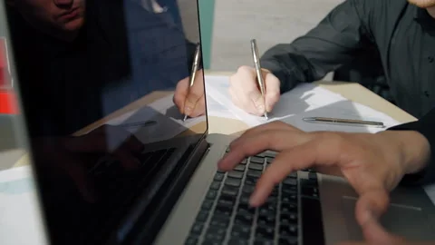 Two businessmen working on project sitting in workplace with laptop in company. Stock Footage 90230977