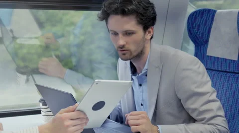 Two businessmen working together on the train Stock Footage 67261736