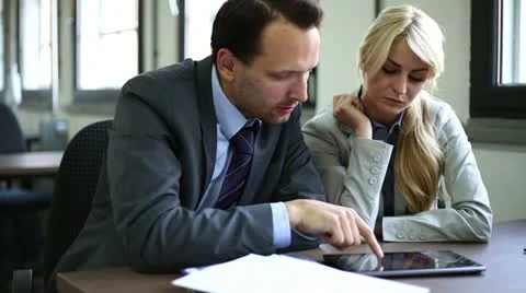 Two businesspeople working on tablet computer in the office 스톡 동영상 11115546