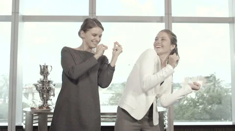 Two Businesswomen Dancing in Office Stock Footage 66517536