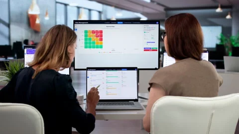 Two Businesswomen Discuss Data Analysis While Working Stock Footage 343890902