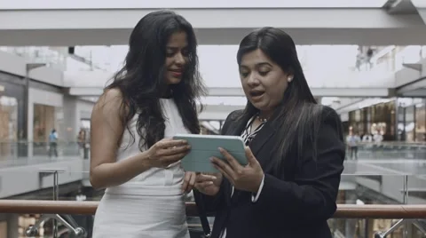 Two Businesswomen Using Tablet in Light Hall Stock Footage 67573541