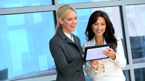 Two Businesswomen Using Wireless Technology Outdoors Stock Footage 7974813