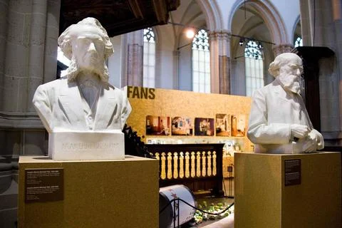Two bust seen from the front with various objects in the background; Exhib... Stock Photos