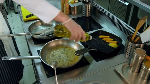Two busy chefs at work cooking in the restaurant kitchen Stock Footage 72325455