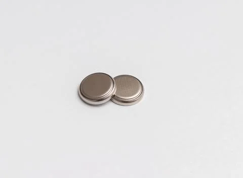 Two button cell or disk cell batteries isolated on white background Foto stock