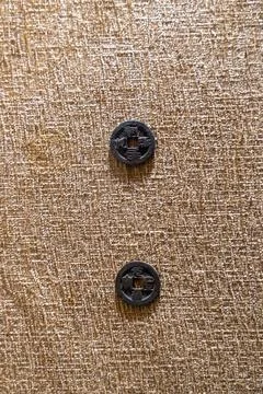 Two buttons are on a tan background. in Chennai Stock-Fotos