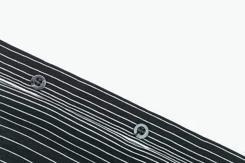 Two buttons on part of a black white linear down shirt Stock Photos