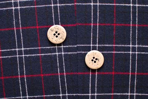 Two buttons on a woolen fabric Stock Photos