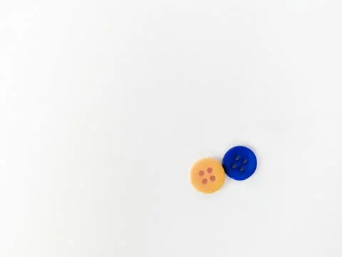 Two buttons, yellow and blue, lie on a white background. Yellow-blue - button Stock Photos