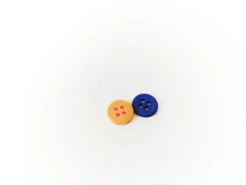 Two buttons, yellow and blue, lie on a white background. Yellow-blue - button Stock Photos