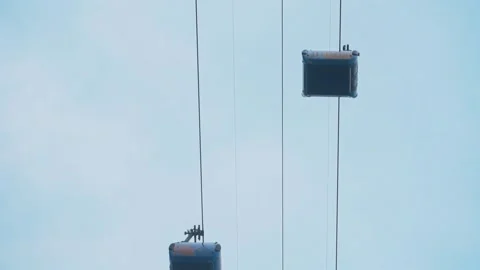 Two cabins of a funicular against the sky are moving in different directions Stock Footage 142927605
