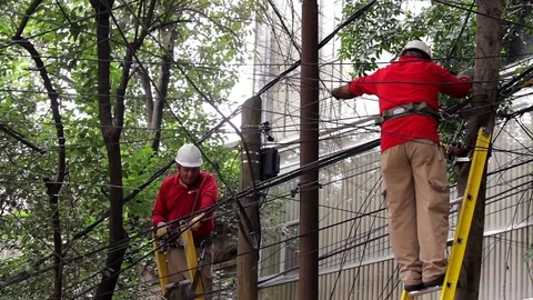 Two cable guys fix some lines, to restore the service Stock Footage 80311444