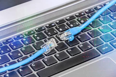 Two cables on computer keyboard symbolizing connection to cyberspace Two c... Stock Photos