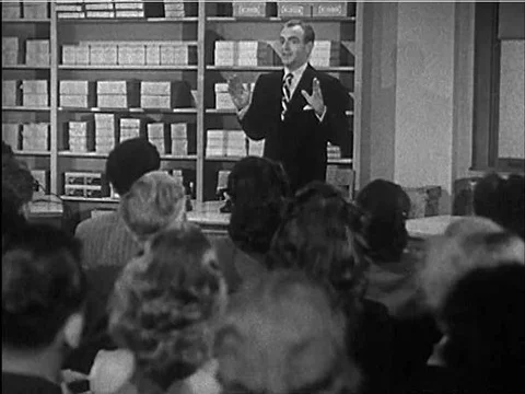 Two cackling friends demonstrate the wrong way to answer a business call in Stock Footage 75201968