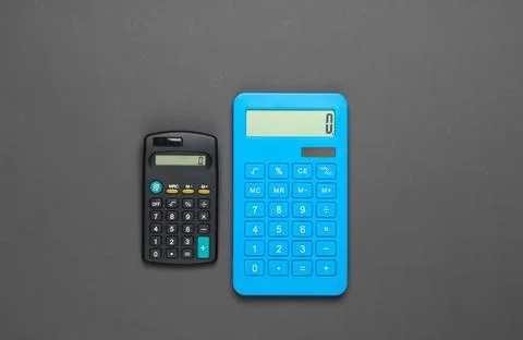 Two calculator on gray background. Calculation or counting. Minimalism. Top v Stockfoto's