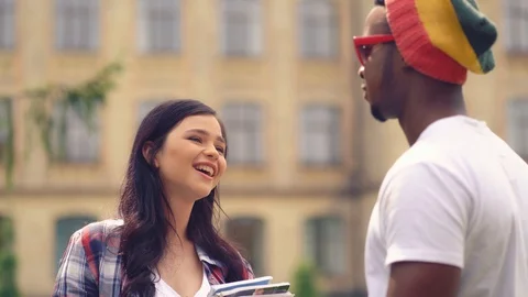 Two callege students having a conversation outside. Stock Footage 127913251
