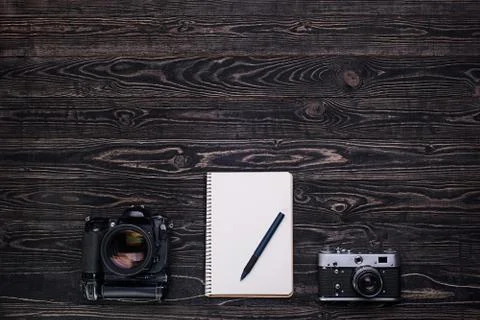 Two cameras and notebook with pen.Top view Stock Photos