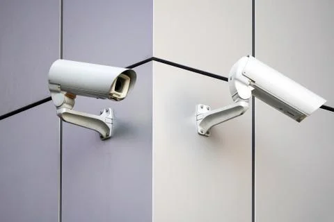 Two cameras CCTV on the facade of a modern office building on the street, sec Foto stock