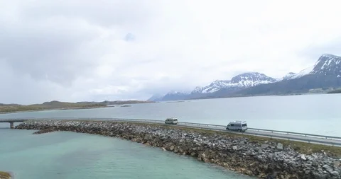 Two campervan crossing the bridge over the lake Stock Footage 86177743